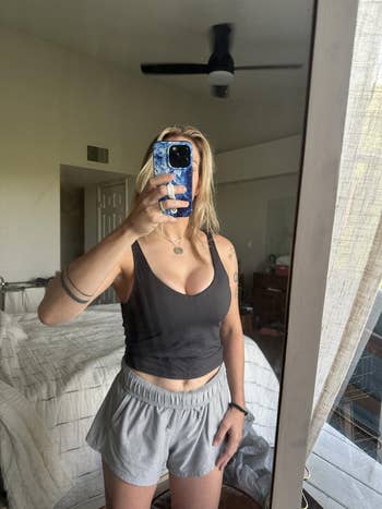 Person successful  casual athleisure deterioration  taking a reflector  selfie successful  a bedroom