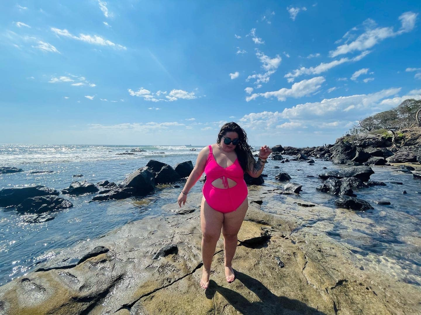 reviewer wearing the pink swimsuit