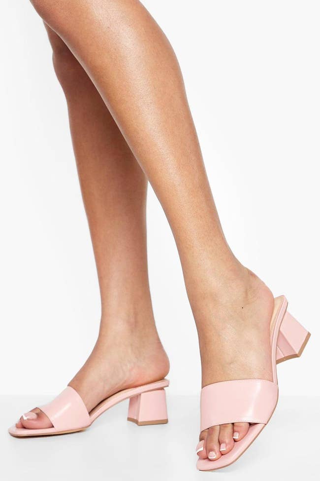 model wearing light pink low-heel sandals