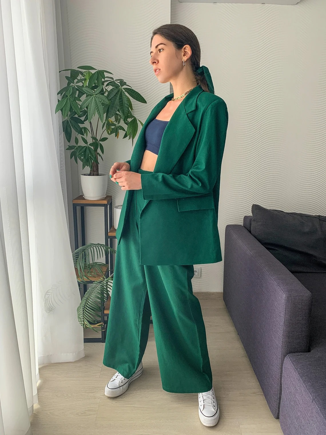 a model posing in a green suit