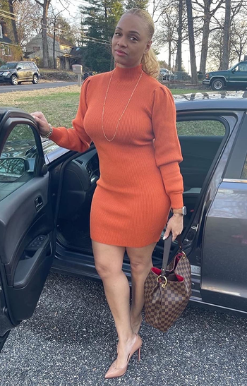 Image of reviewer wearing orange dress
