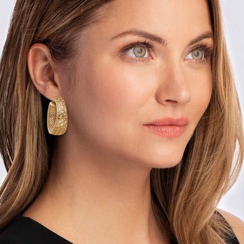 model wearing the gold openwork hoop earrings