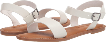 Sode-by-side of white and brown strappy sandal on a white background