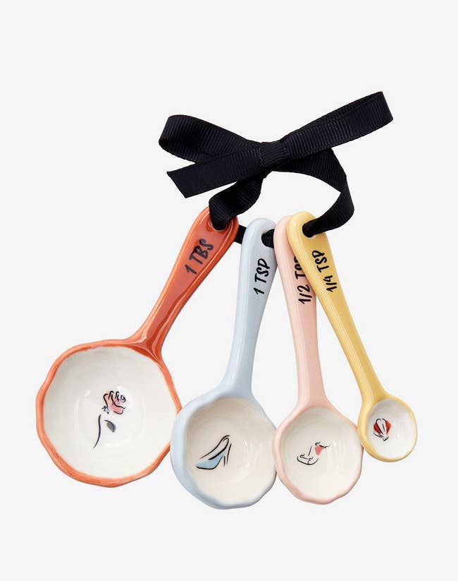 set of four colorful ceramic spoons tied together with a ribbon