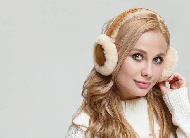 model wearing two toned ear muffs in brown and cream