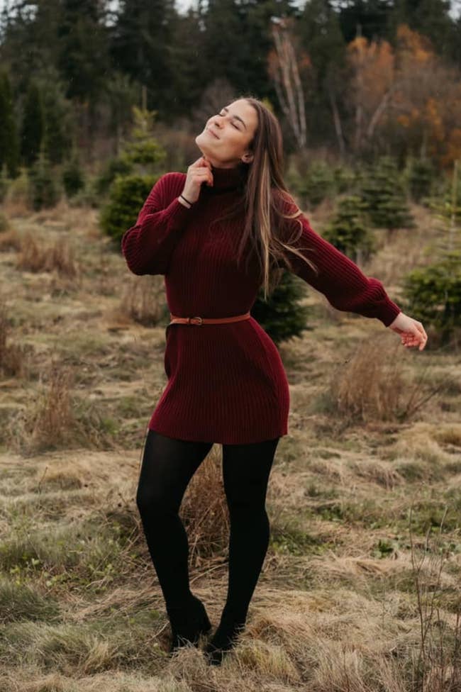a reviewer wearing the dress in burgundy
