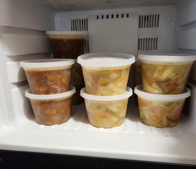 a reviewer's stack of containers in the freezer
