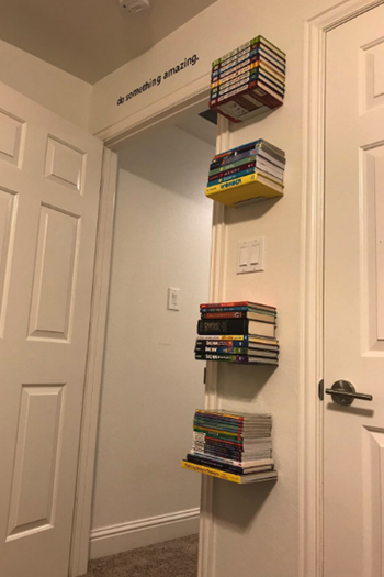 Reviewer photo of the bookshelves up on a wall with books on it