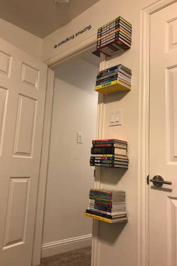 Reviewer photo of the bookshelves up on a wall with books on it