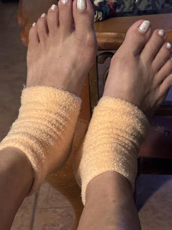 Close-up of feet wearing soft, plush ankle socks, suggesting comfortableness and relaxation