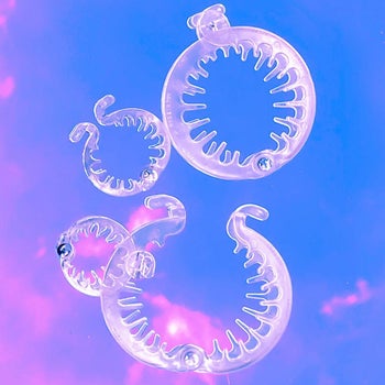 product image of multiple different-sized clear PuffCuffs, against purple and blue sky background