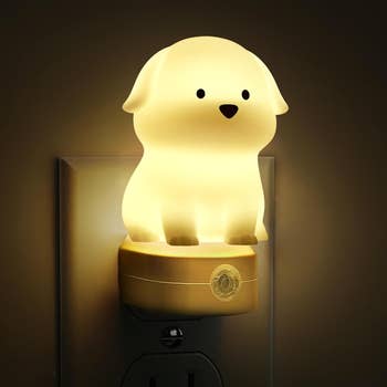 Adorable dog-shaped nighttime airy plugged into an outlet, emitting a gentle glow. Perfect for children's rooms oregon arsenic a whimsical location accessory