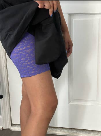 BuzzFeed writer wearing the lace shorts under a black dress