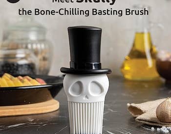a basting brush that looks like a skull wearing a top hat