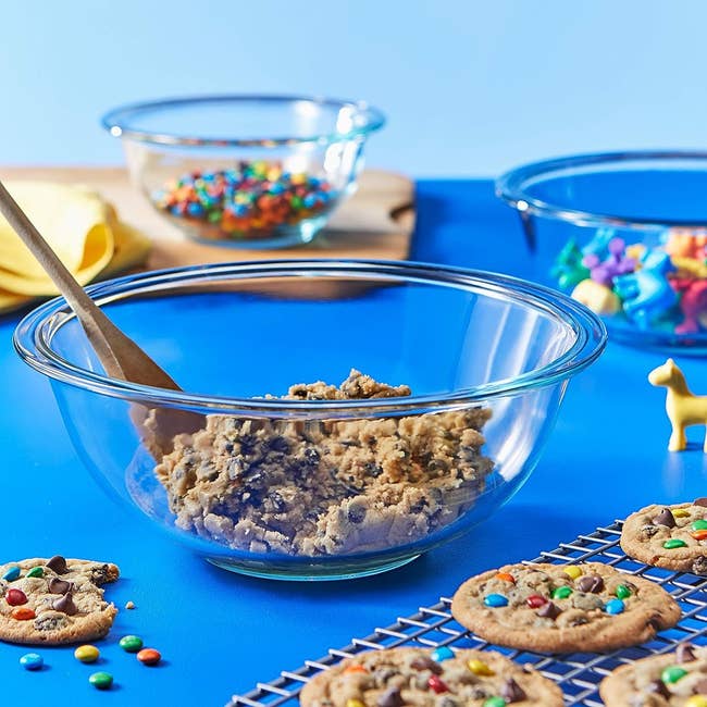 The mixing bowls with cookie dough and sprinkles in them