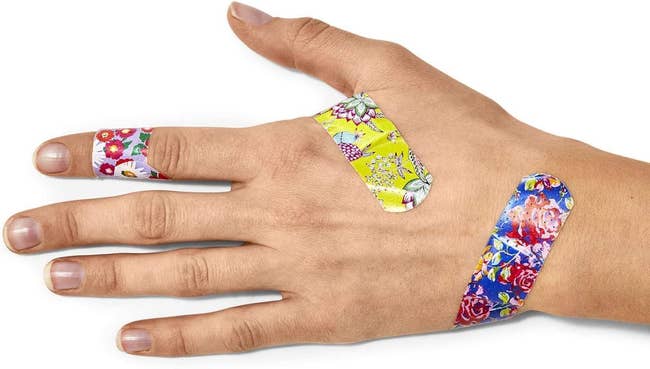 hand with floral patterned bandages