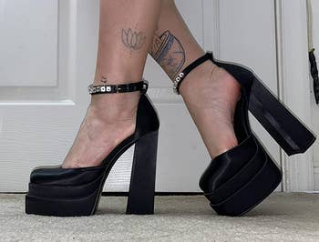 reviewer wearing the black platform heels with embellished ankle straps