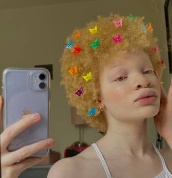 reviewer selfie with butterfly clips throughout afro