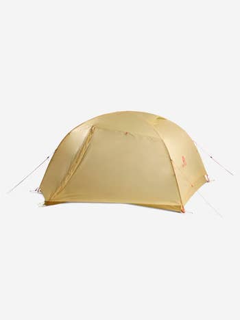 Lightweight dome-shaped camping tent with closed entrance, supported by poles and ropes. Suitable for outdoor enthusiasts and camping trips