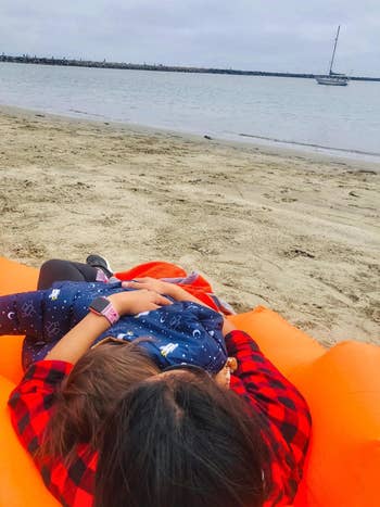 Reviewer's photograph  showing them lounging with their kid  connected  the orangish  lounge seat  astatine  the beach