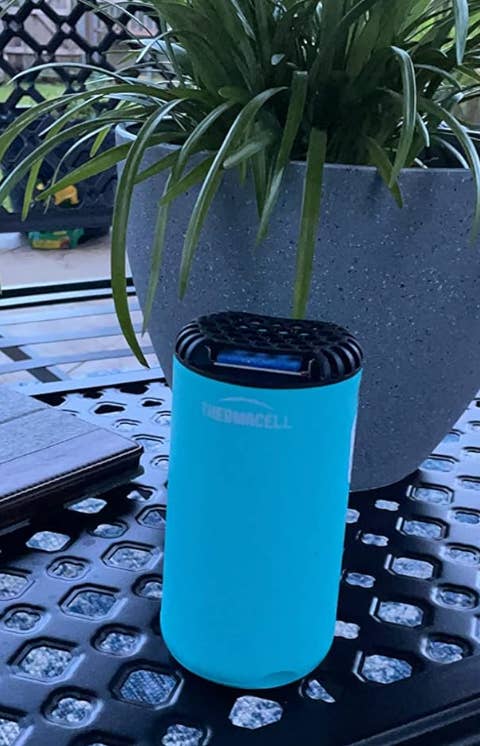 a reviewer's light blue bug repeller on a table