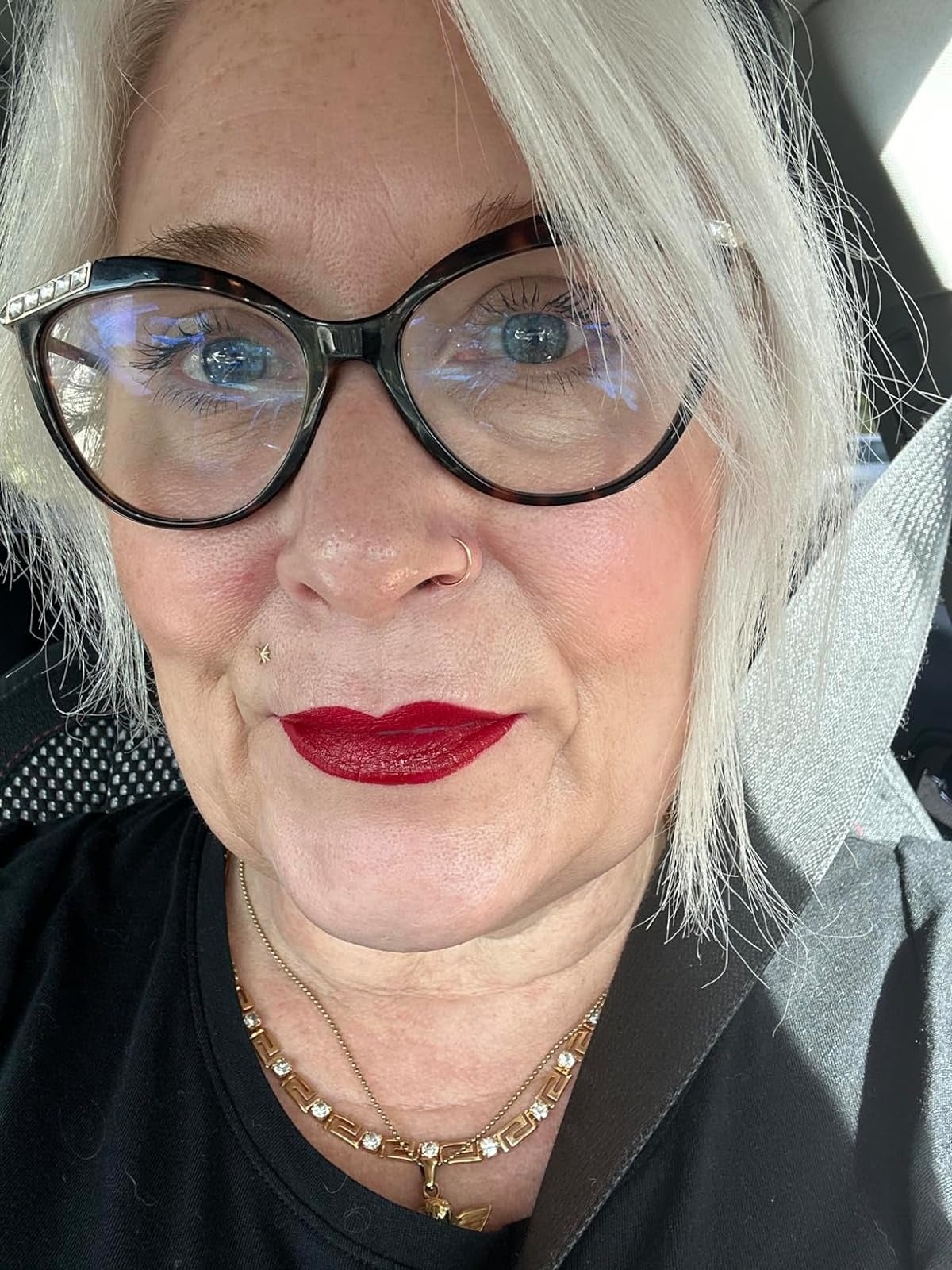 an older reviewer wearing the pioneer red shade of matte lipstick