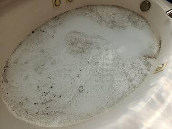 a reviewer's tub filled with suds and grime