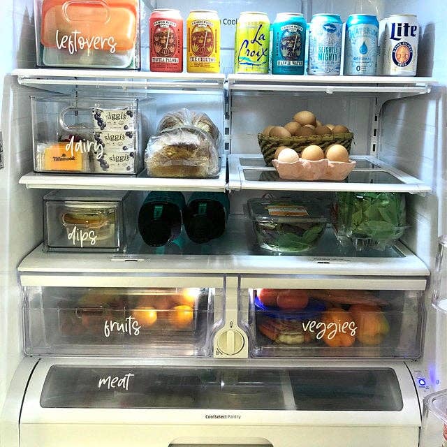 etsy reviewer's fridge with bins labeled in white script font as follows: leftovers, dairy, dips, fruits, veggies, meat