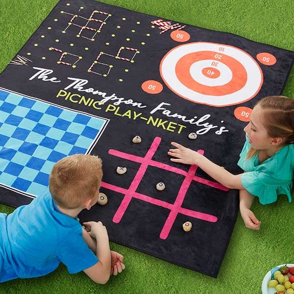 Two children playing tic tac toe on the mat