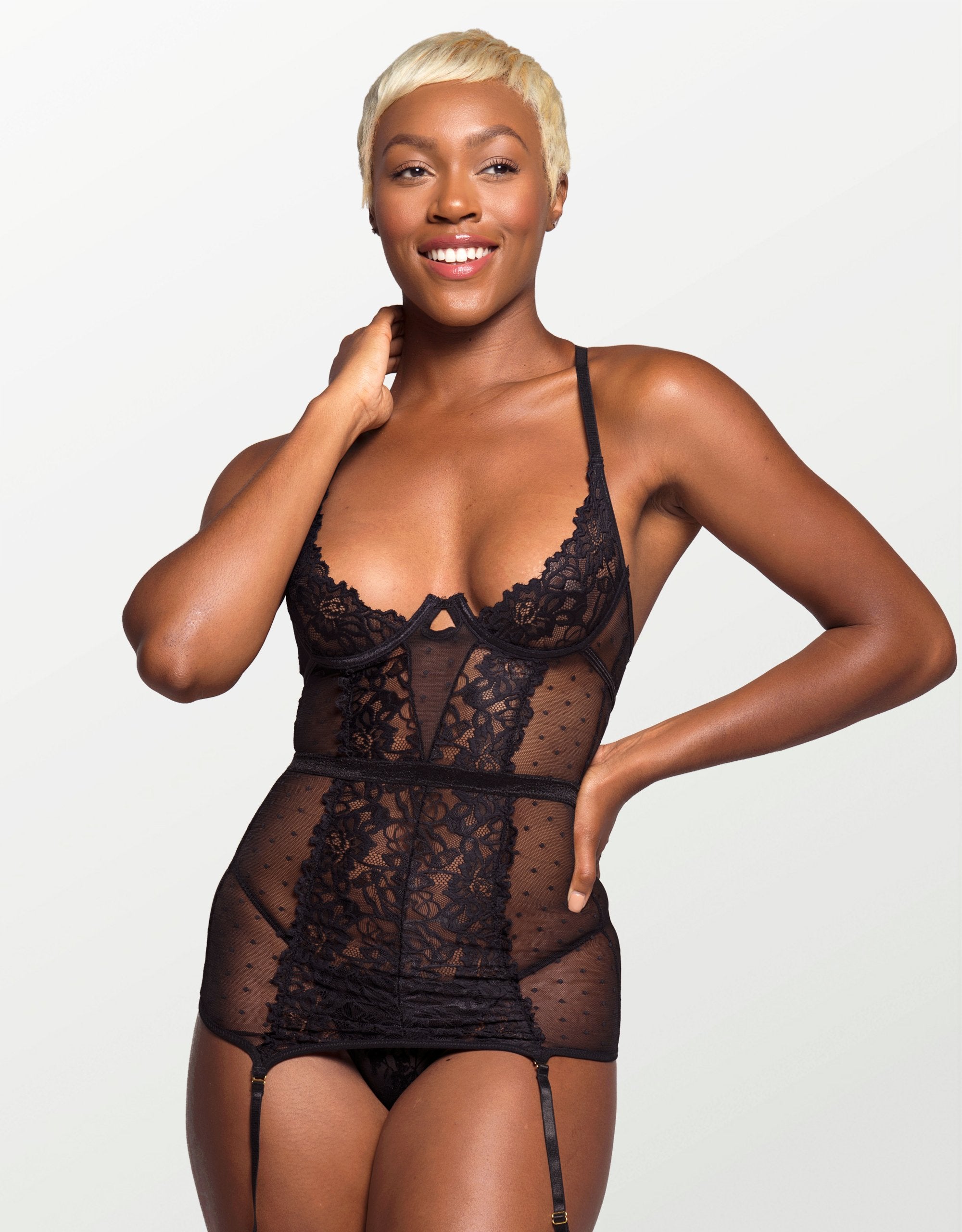 model wearing the set in black, including a chemise with underwires and garter straps