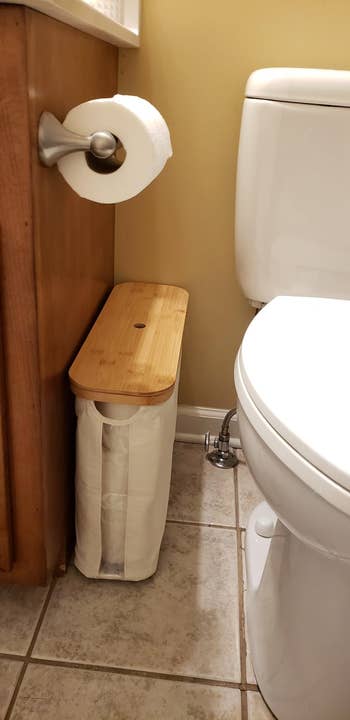 Bathroom country   with toilet insubstantial  rotation  connected  holder and bamboo-topped retention  portion   holding toilet insubstantial  adjacent   the toilet