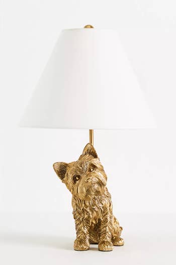 Gold dog-shaped lamp basal  with a achromatic  lampshade, designed for location  decor