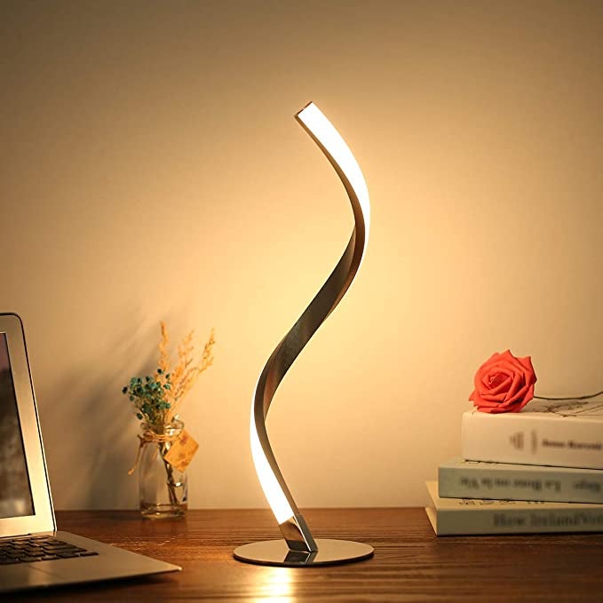 a spiral LED lamp on a desk