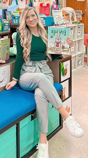 Person successful a schoolroom holding a publication titled
