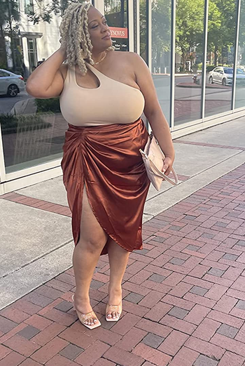 reviewer wearing the bronze-colored skirt