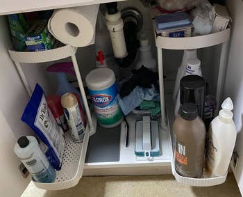 Organized under-sink retention with cleaning supplies, toiletries, and insubstantial towels