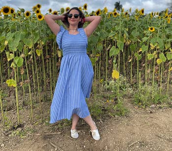 another reviewer wearing the dress in a sunflower field with white oxfords