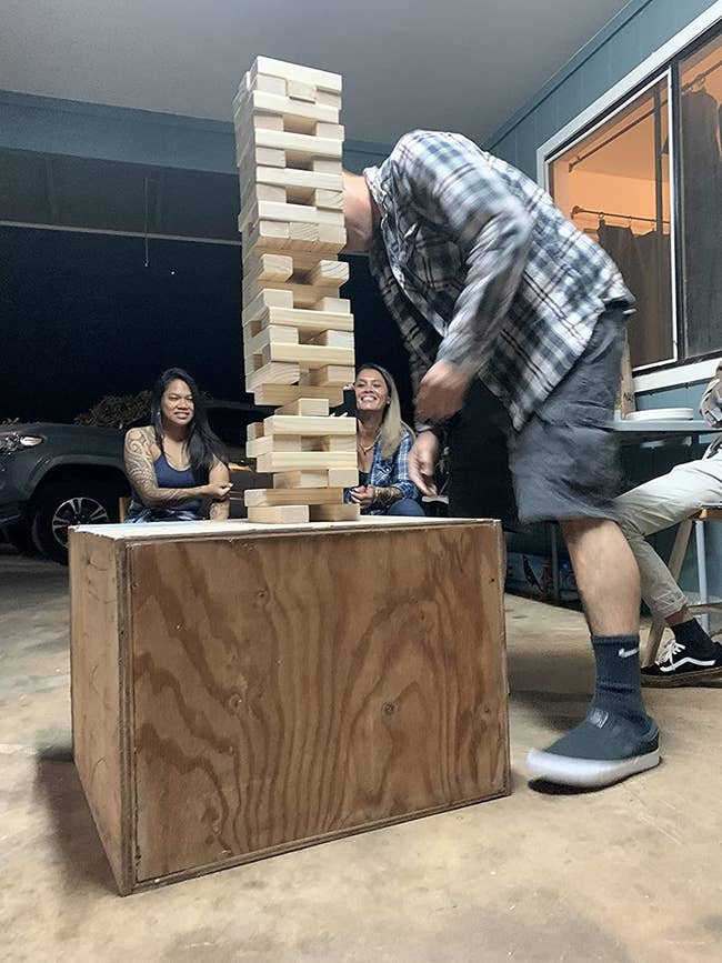 image of reviewer playing the giant stacking game