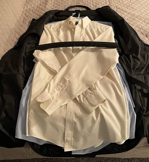 reviewer photo showing dress shirts inside of the garment bag