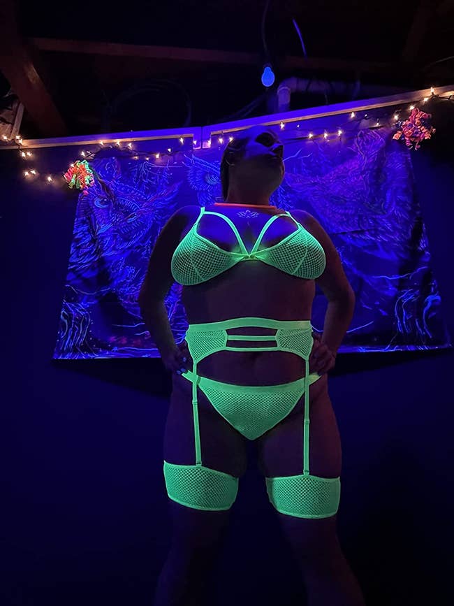 Model posing in glowing neon lingerie set