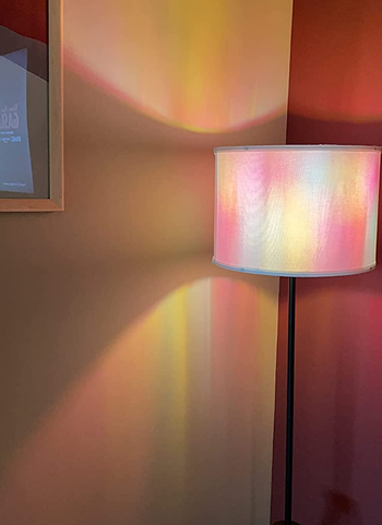 reviewer's floor lamp casts a colorful light pattern on a wall and nearby surfaces