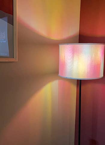 reviewer's floor lamp casts a colorful light pattern on a wall and nearby surfaces