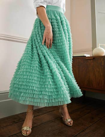 model in the mint skirt with lots of thin tiers of ruffle tool