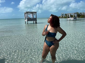 reviewer wearing the swimsuit posing in the ocean