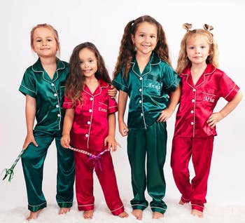 kids in green and red satin pajama sets with names embroidered on the pocket 