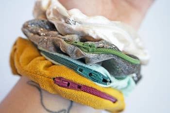 An assortment of different storage scrunchies on a person's wrist