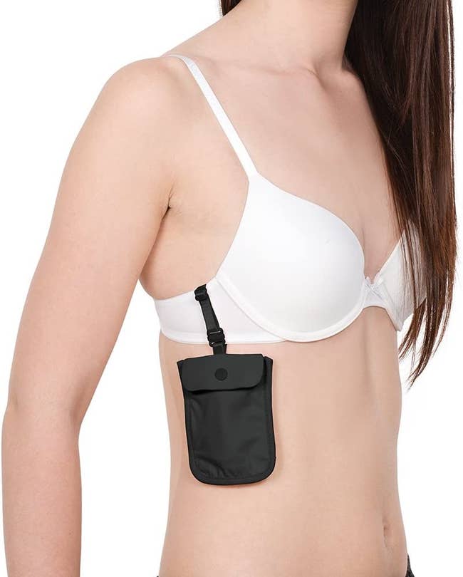 model wearing the black travel pouch, which is attached to their bra