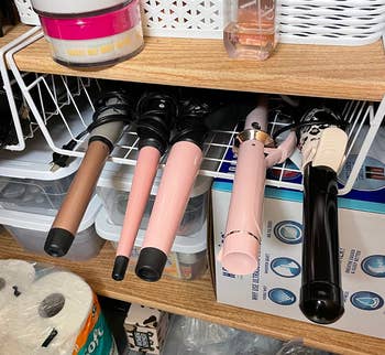 same reviewer showing another under-shelf basket being used for styling tools