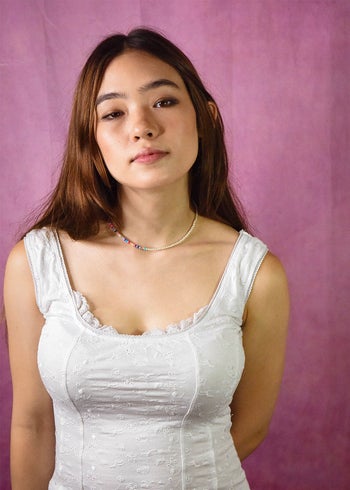 a model wearing a half pearl/half beaded necklace