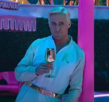 ryan gosling as ken drinking from the gold wine glass